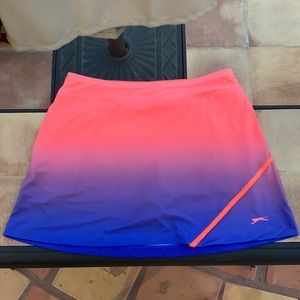 A pink fading into a purple tennis skirt